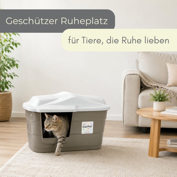 GarPet Katzenhaus in einem hellen Wohnzimmer, eine Katze tritt aus der Öffnung hervor.