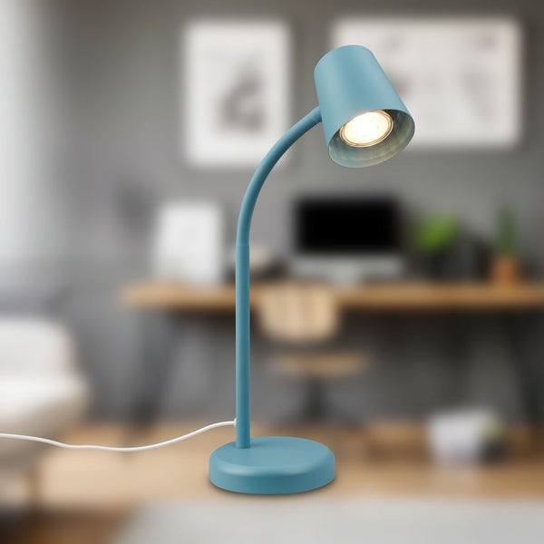 Blaue LED-Schreibtischleuchte mit flexiblem Arm und rundem Fuß, eingeschaltet, in einem modernen, hellen Arbeitszimmer.