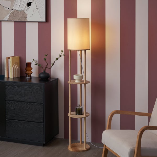 Stehleuchte aus Holz mit integrierten Ablageflächen und Lampenschirm in modernem Wohnzimmer mit gestreifter Wand