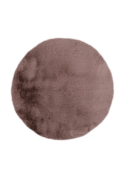 Runder altrosafarbener Kunstfellteppich mit weichem Hochflor.