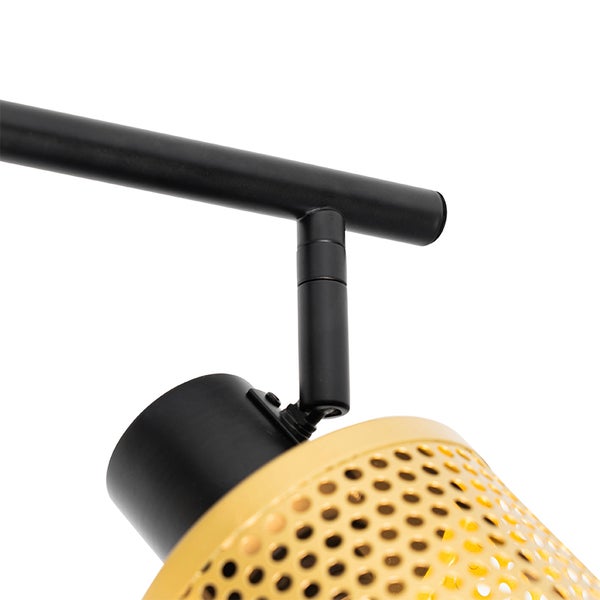 Nahaufnahme einer Deckenschiene mit einem gelochten Lampenschirm