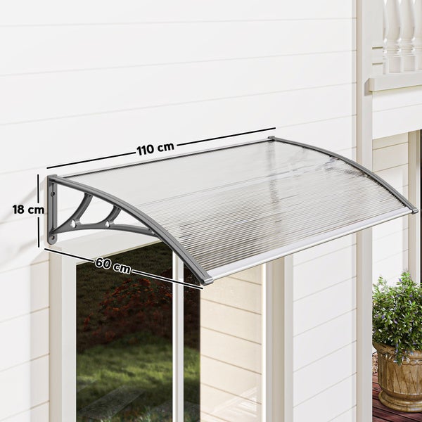 Pultvordach aus transparentem Polycarbonat mit grauen Kunststoffträgern, Breite 110 Zentimeter, Tiefe 60 Zentimeter, Höhe 18 Zentimeter.