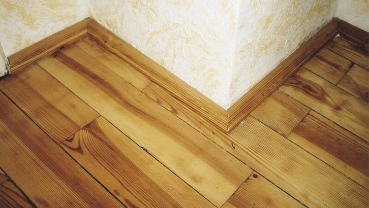Eckansicht von Holzfußboden und Sockelleisten