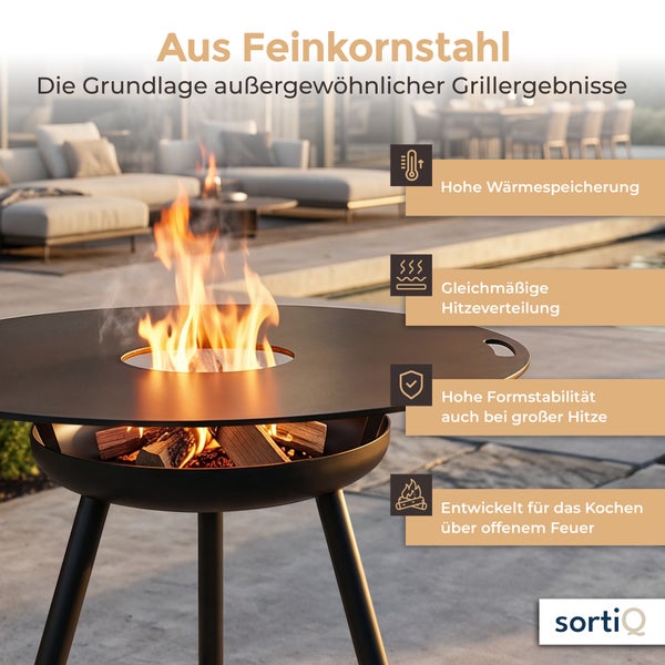 Feuerstelle aus Feinkornstahl mit Grillring und Holzfeuer für das Kochen im Freien, inklusive Vorteile wie Wärmespeicherung und Hitzeverteilung.