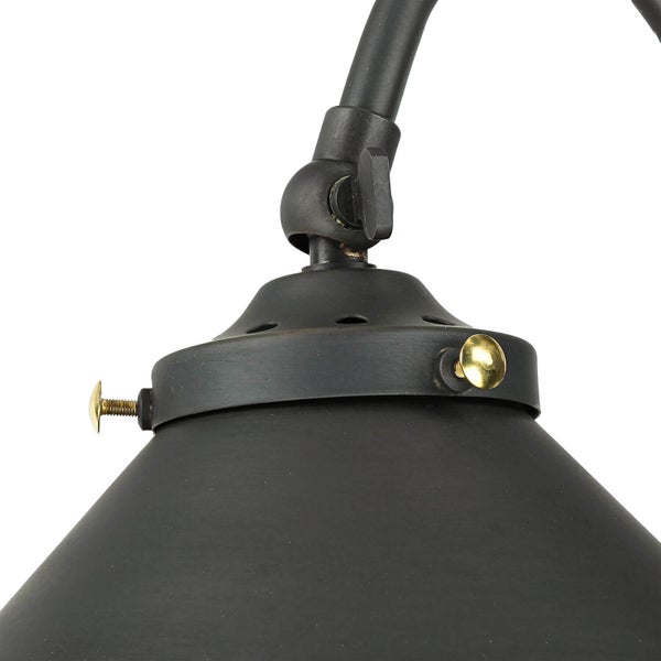 Detailaufnahme einer schwarzen Lampe mit goldenen Schrauben