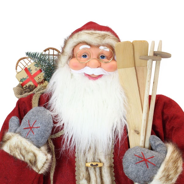 Weihnachtsmann Dekofigur mit Skiern und Geschenkesack