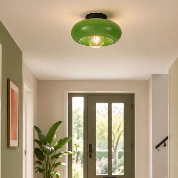Moderne Deckenleuchte mit grünem Glasschirm im Flur eines Hauses mit Eingangstür und Zimmerpflanze.