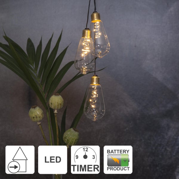 Drei hängende LED-Glühbirnen mit Batteriebetrieb und Timer-Funktion neben einer Pflanze