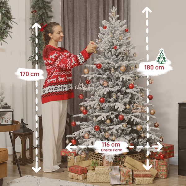 Eine Frau dekoriert einen künstlichen, beschneiten Weihnachtsbaum mit einer Höhe von 180 Zentimetern und einer Breite von 116 Zentimetern.
