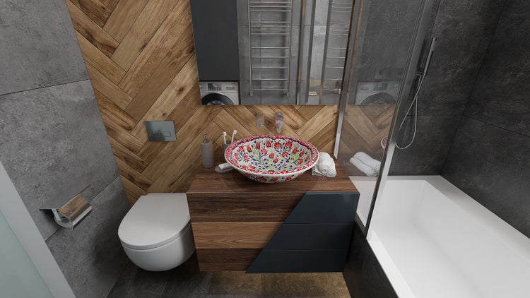 Helles Badezimmer mit Waschbecken, Toilette, Badewanne und Waschmaschine.