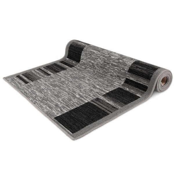 Teppich mit geometrischem Muster, teilweise aufgerollt