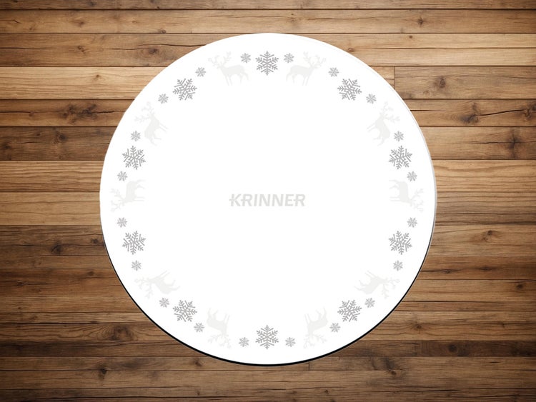 Runde Krinner Weihnachtsbaumunterlage mit Muster aus Schneeflocken und Rentieren sowie Krinner Logo.