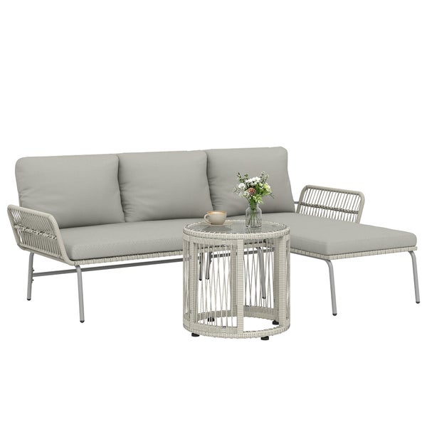 Modernes Garten-Loungeset aus grauem Geflecht auf einer sonnigen Terrasse, bestehend aus Sofa mit Liegefläche und rundem Beistelltisch.