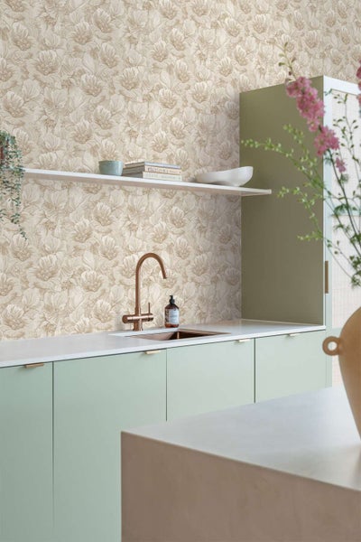 Moderne Kueche mit floraler Tapete in beige und weiss kombiniert mit schlichten hellgruenen Kuechenfronten und einer Arbeitsplatte mit Spuelbecken.
