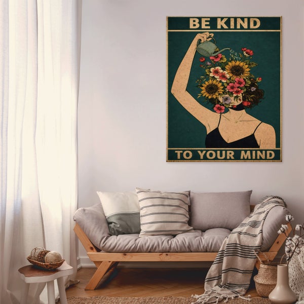 Wandbild mit der Aufschrift Be Kind To Your Mind in einer modern eingerichteten Wohnlandschaft mit Sofa und Dekokissen.