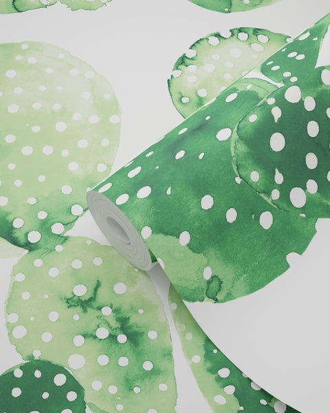 Tapetenrolle mit grünem Punktmuster auf weißem Grund