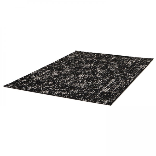Rechteckiger Teppich mit abstraktem Vintage-Muster in Schwarz und Weiß.