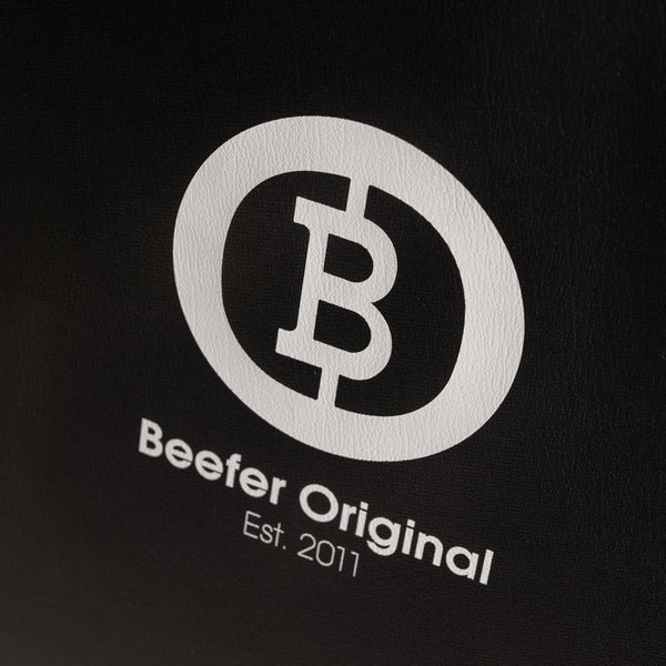 Nahaufnahme von schwarzem strukturiertem Material in Lederoptik mit einer Naht.