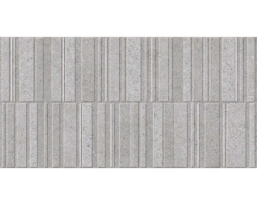 Graue Betonsteinmauer mit vertikalen Rillen