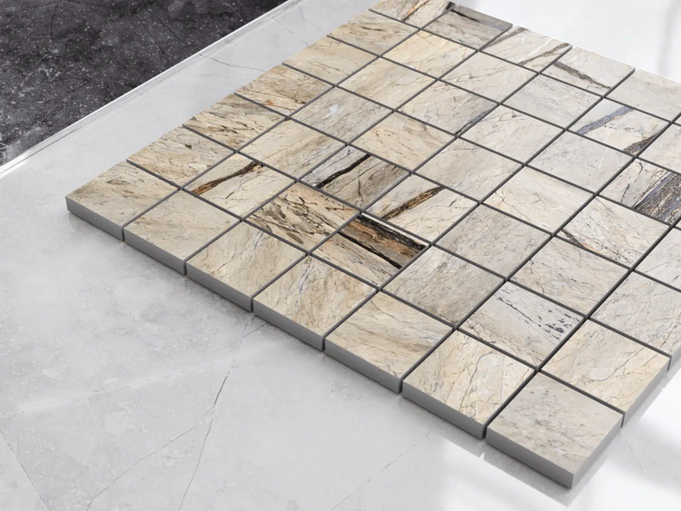 Quadratische Mosaikfliese in Natursteinoptik mit beige-brauner Maserung.