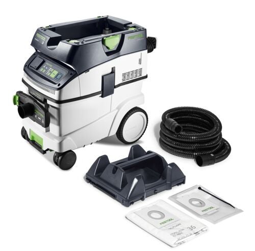 Festool Absaugmobil mit Langhalsschleifer auf einer Baustelle mit verputzten Wänden und Betonboden.