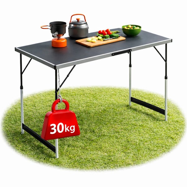 Klappbarer Campingtisch aus Metall mit Kochutensilien, belastbar bis 30 Kilogramm auf einer Grasfläche.
