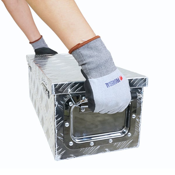 Eine Person mit Proregal Arbeitshandschuhen hebt eine Transportbox aus Aluminium-Riffelblech am seitlichen Griff an.