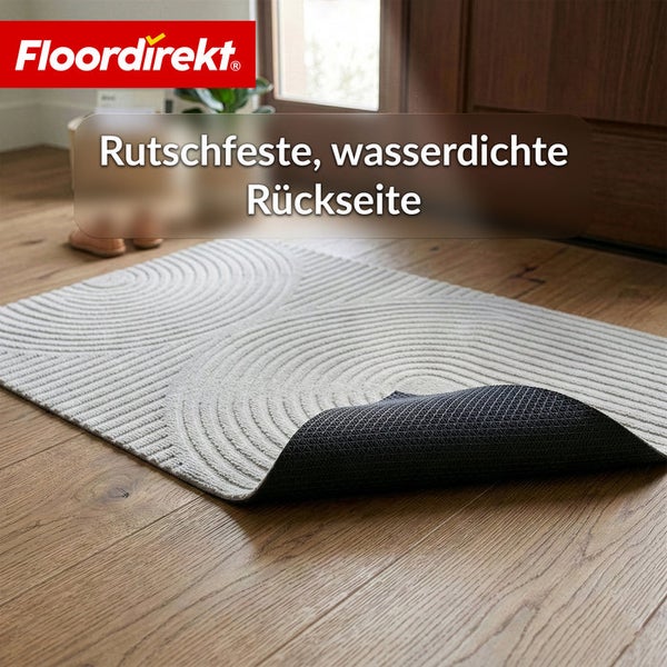 Floordirekt Logo. Fußmatte mit Kreis-Struktur und rutschfester, wasserdichter Rückseite auf Holzboden.