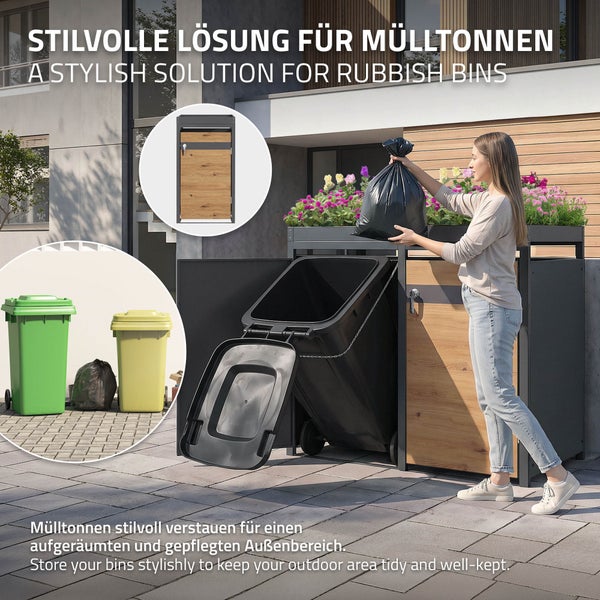Moderne Mülltonnenbox aus Metall und Holzoptik mit Pflanzdach im Außenbereich, eine Person wirft einen Müllbeutel ein.