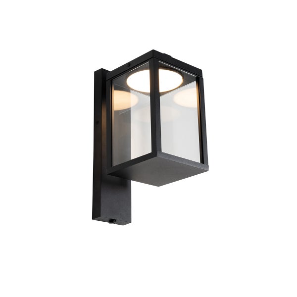 Schwarze Außenwandleuchte in Laternenform aus Metall und Glas mit integriertem LED-Leuchtmittel.