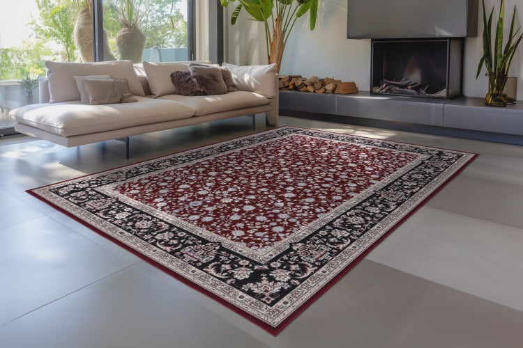 Rechteckiger Orientteppich mit floralem Muster in einem modernen Wohnzimmer vor einem Kamin.