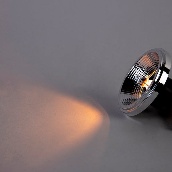 Eingeschalteter LED-Strahler mit Facettenreflektor und warmweißem Lichtkegel.