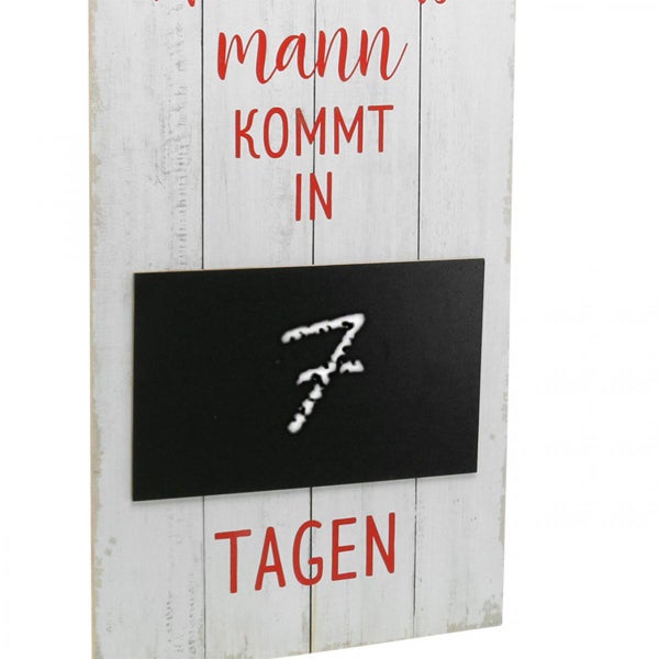 Dekoschild mit der Aufschrift 'Der Weihnachtsmann kommt in Tagen' und einer Tafel mit der Zahl sieben.