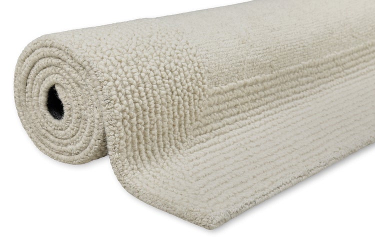 Gerollter Badteppich mit strukturierter Oberfläche aus weichem Material.