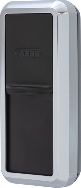 ABUS Schlüsseltresor mit silbernem Metallgehäuse und schwarzer Schiebeabdeckung.