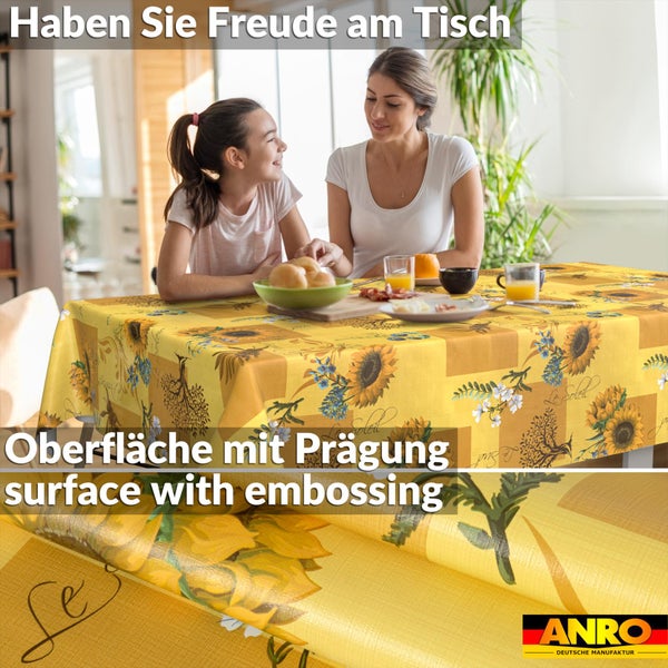 Abwaschbare Tischdecke mit Sonnenblumenmuster und geprägter Oberfläche, gedeckter Tisch mit Frau und Kind, ANRO Logo.