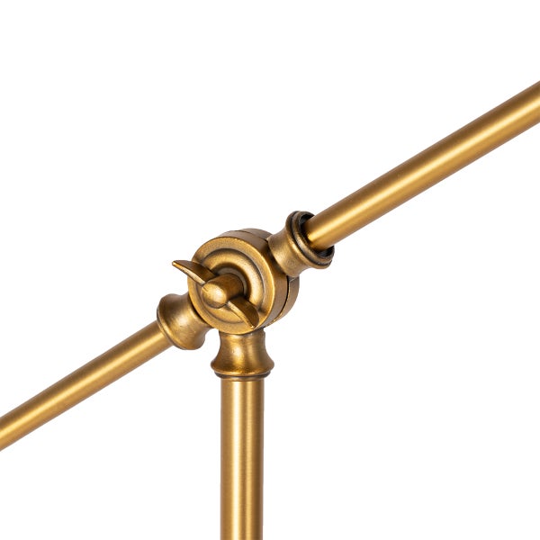 Detail einer goldenen Leuchte mit Schraubverbindung