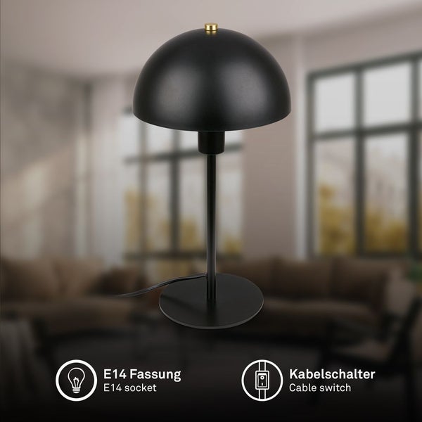 Moderne schwarze Tischleuchte aus Metall mit rundem Schirm, E14 Fassung und Kabelschalter in einem hellen Wohnzimmer.