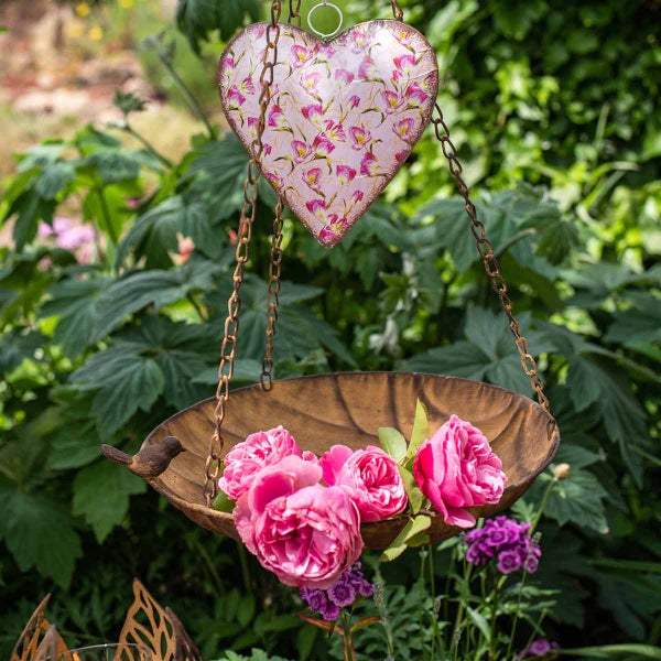 Dekorative Vogeltränke mit Herzaufhängung und Rosenblüten