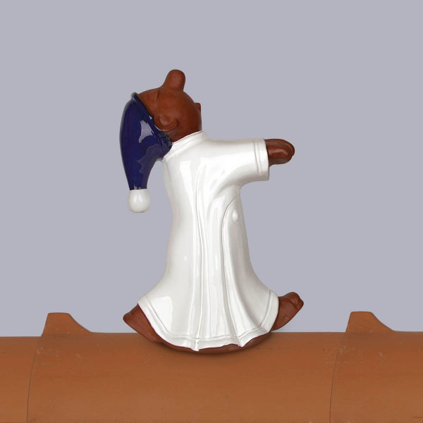 Dachfigur Schlafwandler aus glasierter Keramik auf einem Firstziegel.