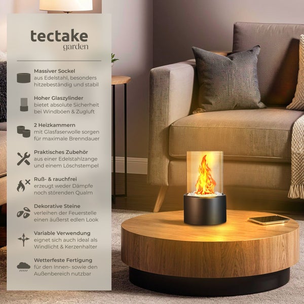 Tectake Tischkamin mit Edelstahlfuß, Glaszylinder und dekorativen Steinen auf einem runden Tisch neben einem Sofa