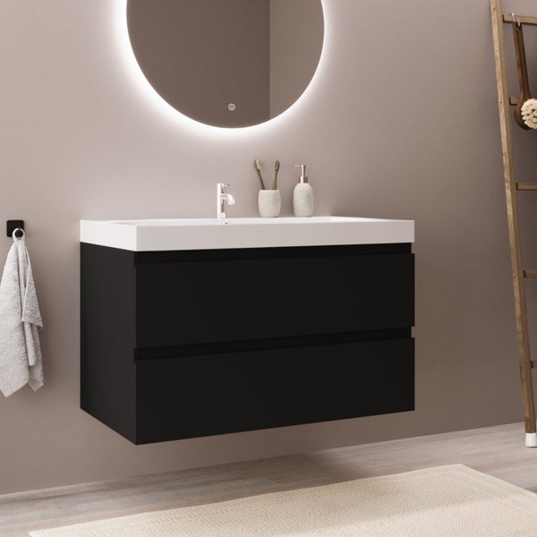 Wandhängender schwarzer Waschbeckenunterschrank mit weißem Waschbecken und rundem Leuchtspiegel in modernem Badezimmer.