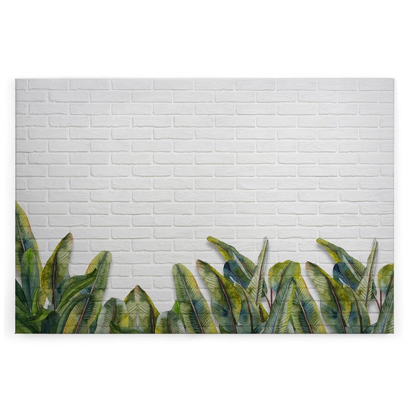 Wandbild mit Motiv von tropischen Pflanzenblättern vor einem Ziegelsteinmauer Hintergrund