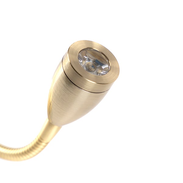 Nahaufnahme einer goldenen Leselampe mit flexiblem Arm