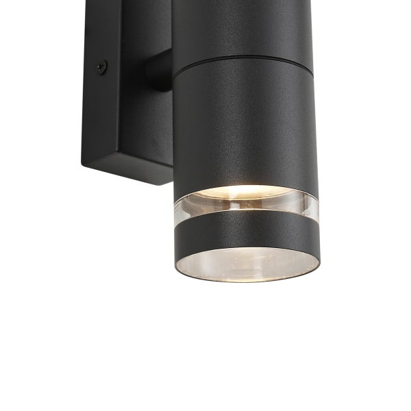 Zylinderförmige Außenwandleuchte aus anthrazitfarbenem Metall mit transparentem Lichtring und nach unten gerichteter Beleuchtung.