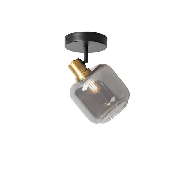 Einflammiger Deckenstrahler mit schwarzer Basis, messingfarbener Fassung und rauchgrauem Glasschirm.