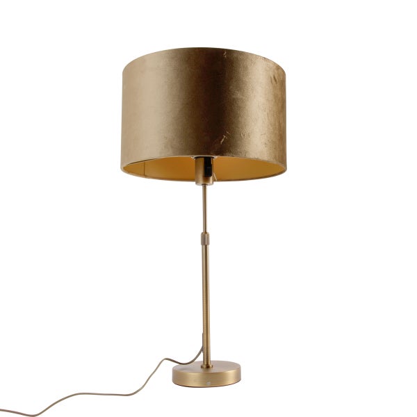 Tischleuchte mit goldfarbenem Metallfuß und zylindrischem Schirm aus goldfarbenem Samt.