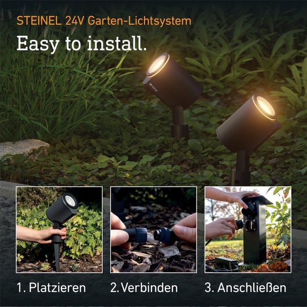 Steinel 24 Volt Garten-Lichtsystem: Zwei Strahler im Garten. Drei Schritte: Strahler platzieren, Kabel verbinden und an Stromsäule anschließen.