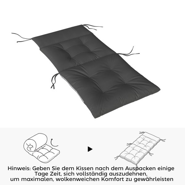 Dunkelgraue Polsterauflage für Gartenliegen mit Steppung und Haltebändern inklusive Hinweis zur Entfaltung nach dem Auspacken.