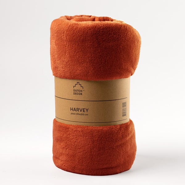 Gerollte orangefarbene Kuscheldecke mit Papierbanderole